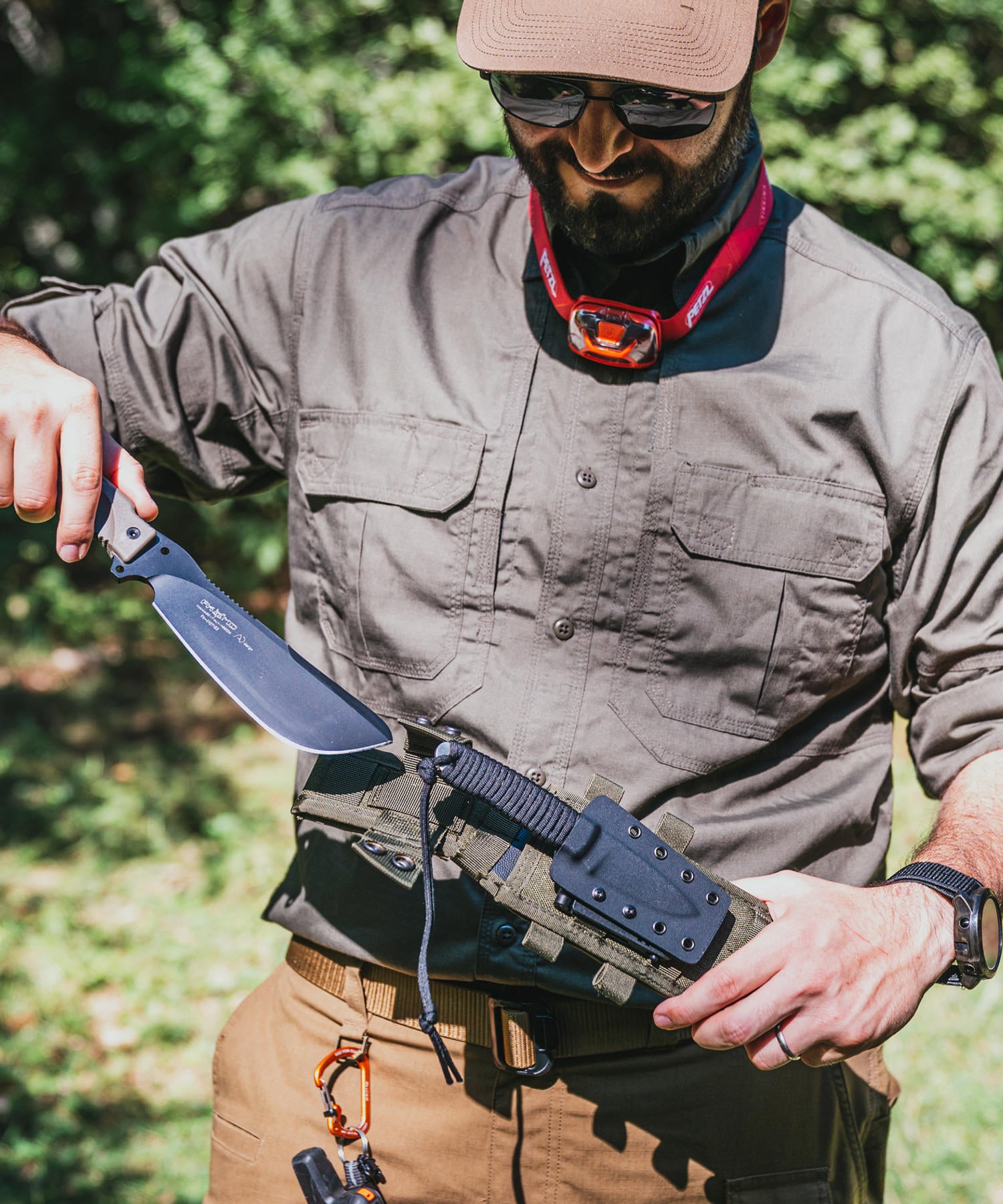 Paolo di backpacco estrae il parang per preparare il campo per la notte