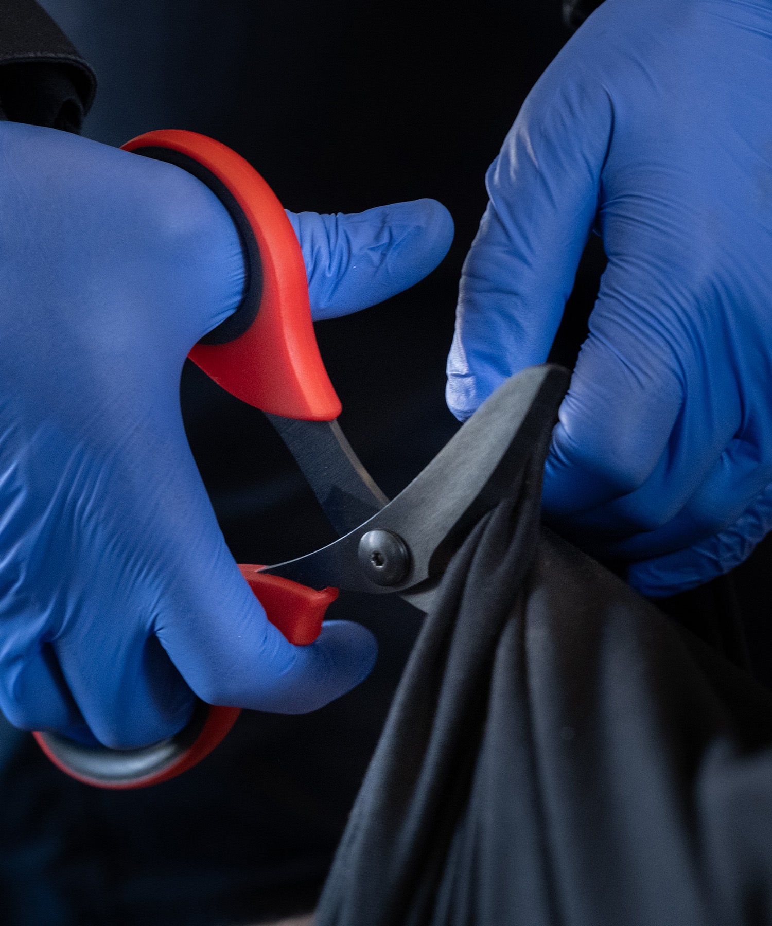 forbici xshears rosse durante il taglio di un pantalone