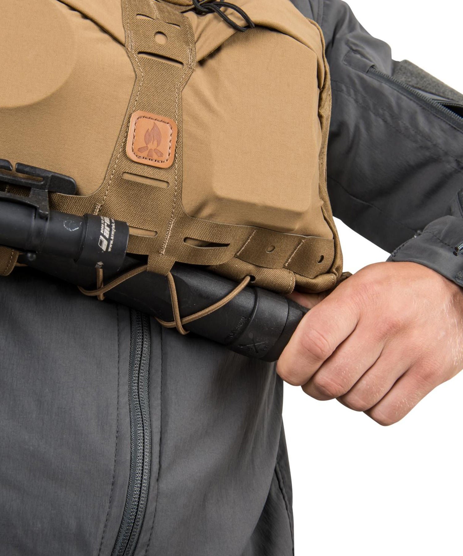 uomo indossa un chest pack numbat di helikon-tex e sfila il coltello